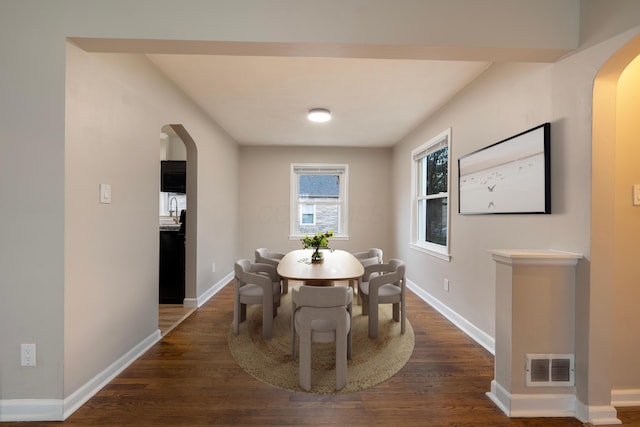 dining room with dark wood-type flooring