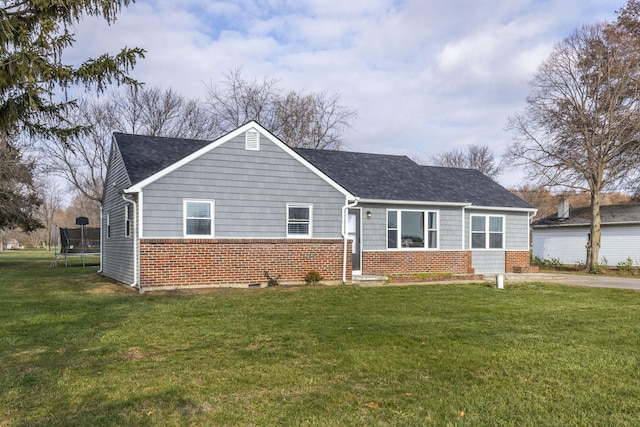 view of front of property with a front yard and a trampoline