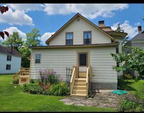 rear view of property featuring a yard