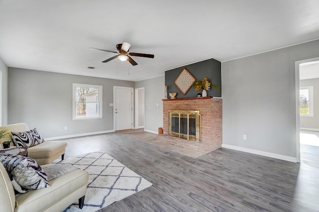 living room featuring ceiling fan, a fireplace, and hardwood / wood-style flooring