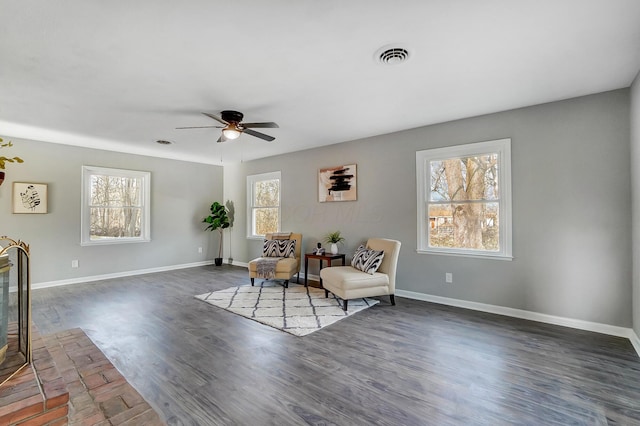 living area featuring dark hardwood / wood-style flooring and ceiling fan