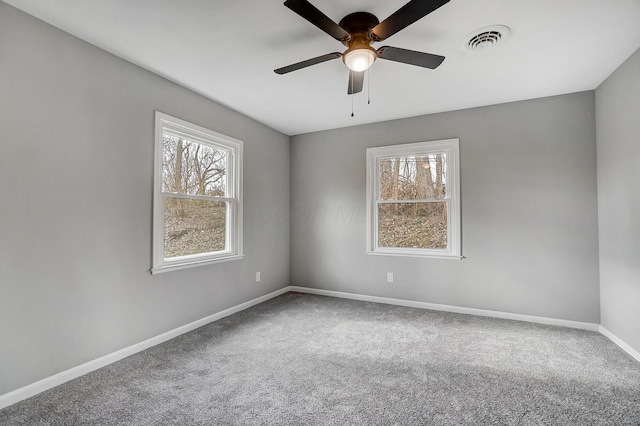 unfurnished room with carpet flooring, a wealth of natural light, and ceiling fan