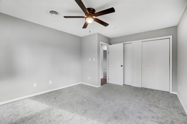 unfurnished bedroom featuring multiple closets, ceiling fan, and carpet