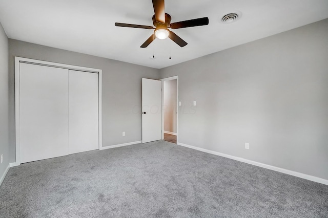 unfurnished bedroom featuring ceiling fan, a closet, and carpet floors