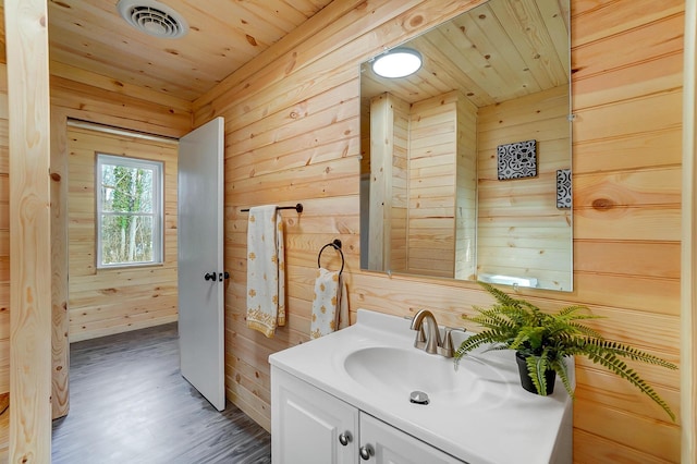 bathroom with vanity, wood walls, wood-type flooring, and wood ceiling