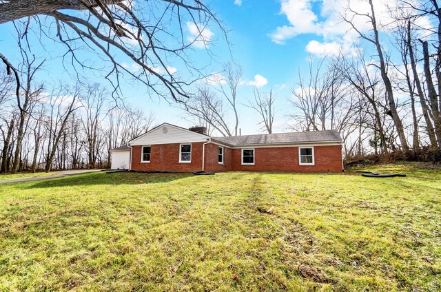 rear view of property featuring a yard