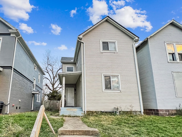 rear view of house featuring a yard