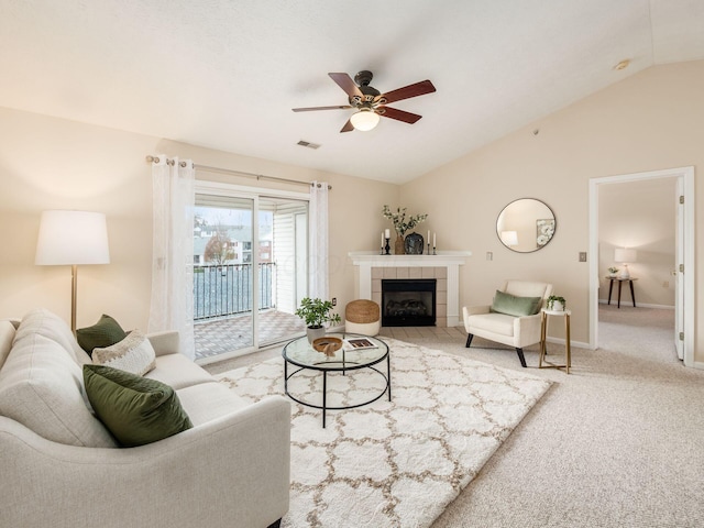 living room featuring a fireplace, carpet floors, ceiling fan, and lofted ceiling