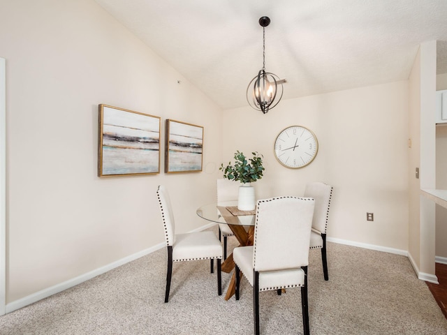 dining area featuring carpet, lofted ceiling, and an inviting chandelier