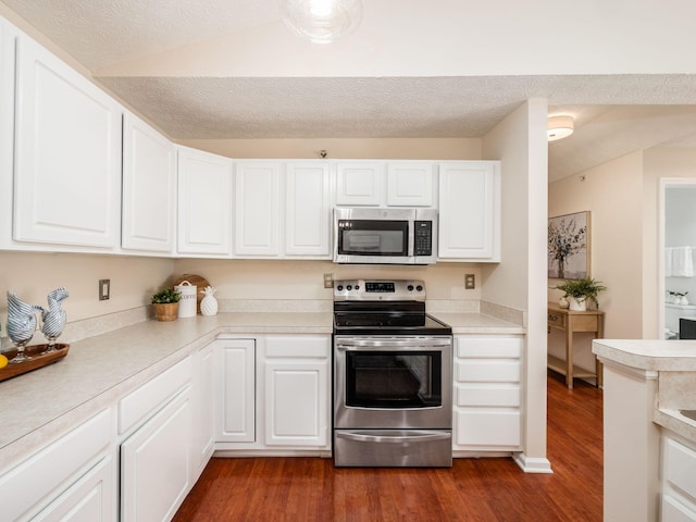 kitchen with white cabinetry, dark wood-type flooring, stainless steel appliances, and a textured ceiling