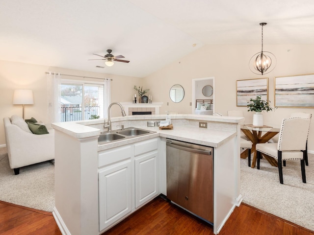 kitchen featuring sink, pendant lighting, dishwasher, dark hardwood / wood-style floors, and white cabinetry