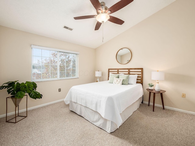 carpeted bedroom with ceiling fan and vaulted ceiling