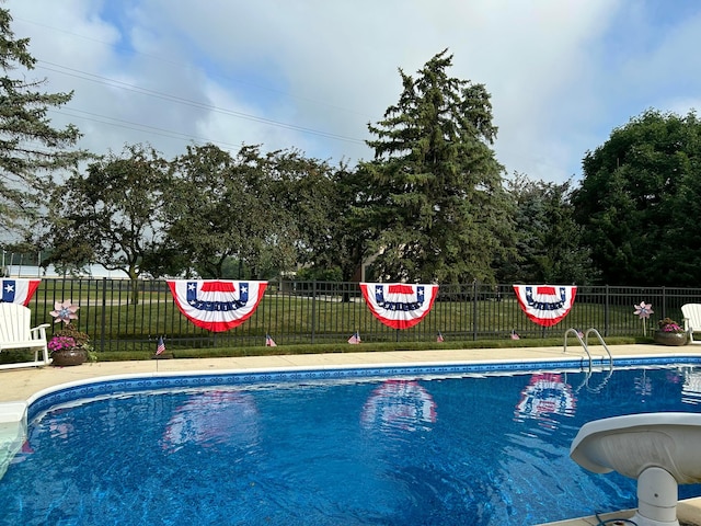 view of pool featuring a yard