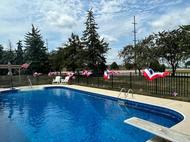 view of pool with a diving board