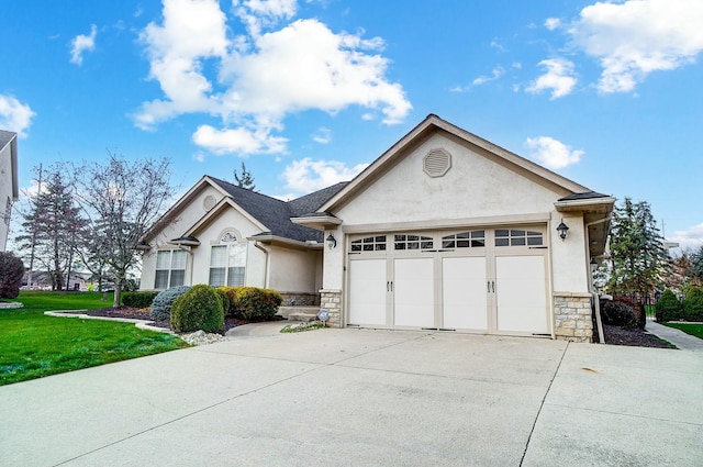 view of front of property with a garage and a front yard