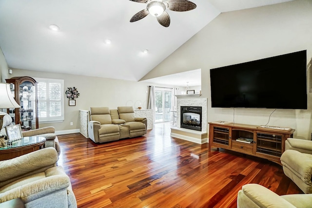 living room with ceiling fan, hardwood / wood-style floors, high vaulted ceiling, and a healthy amount of sunlight