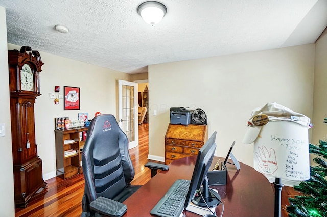 office with french doors, a textured ceiling, and dark wood-type flooring