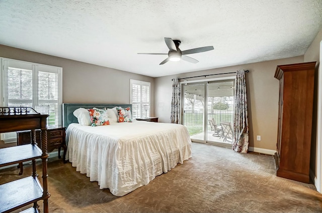 bedroom with ceiling fan, dark carpet, a textured ceiling, and access to outside