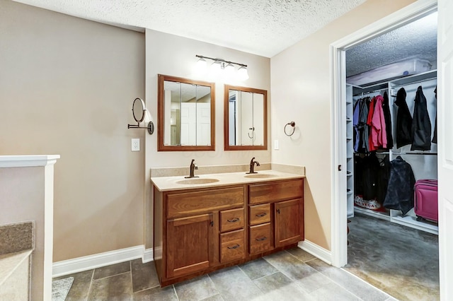 bathroom featuring vanity and a textured ceiling