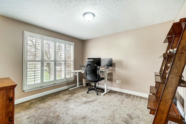 home office with a textured ceiling and light carpet