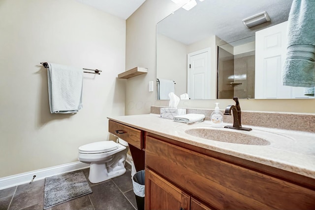 bathroom featuring tile patterned flooring, vanity, and toilet