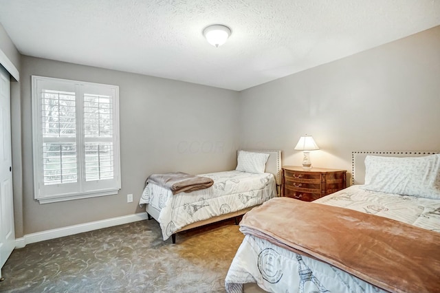 bedroom featuring carpet floors and a textured ceiling