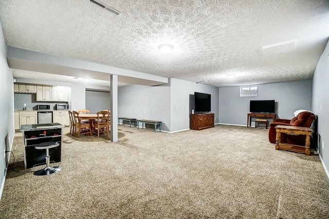 living room featuring carpet and a textured ceiling