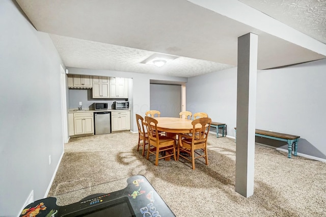 carpeted dining area with a textured ceiling and sink