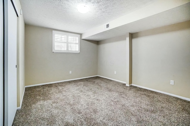 basement with carpet floors and a textured ceiling