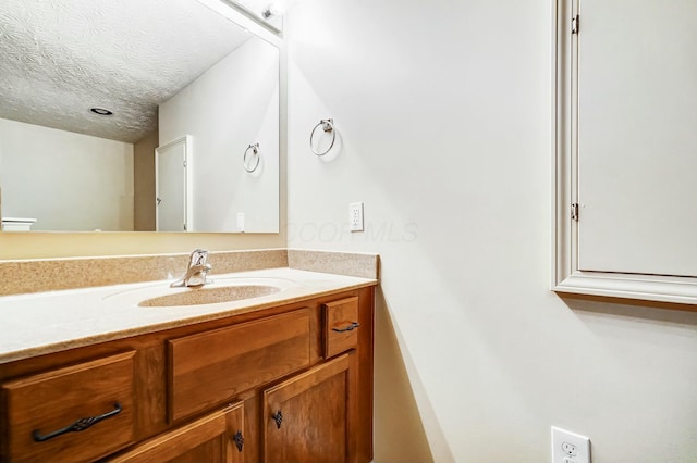 bathroom featuring vanity and a textured ceiling