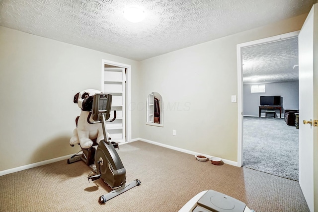 workout room with carpet and a textured ceiling