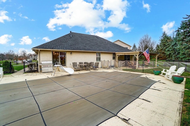 view of swimming pool featuring a patio and grilling area