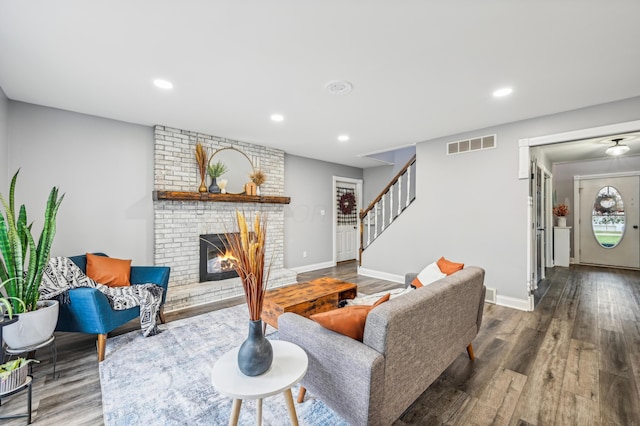 living room with wood-type flooring and a fireplace