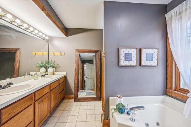 bathroom featuring tile patterned flooring, vanity, and a tub