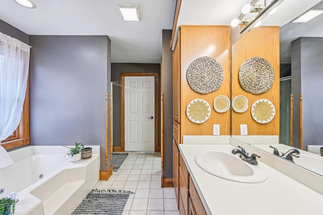 bathroom featuring vanity, tile patterned floors, and a tub