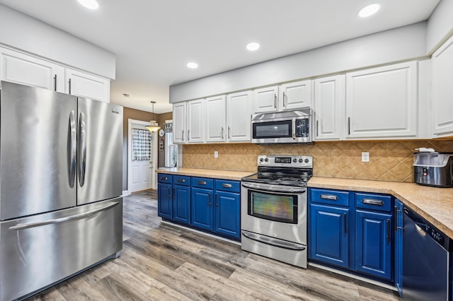 kitchen featuring white cabinetry, light hardwood / wood-style flooring, blue cabinets, and appliances with stainless steel finishes