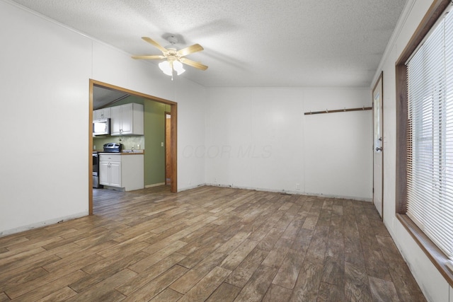 interior space featuring a textured ceiling, hardwood / wood-style flooring, and ceiling fan