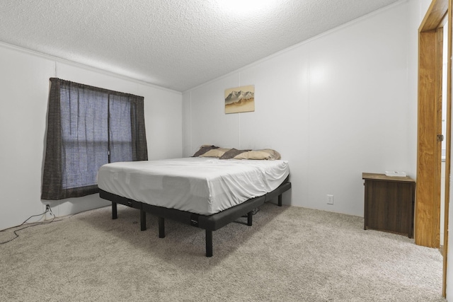 bedroom with light colored carpet and a textured ceiling