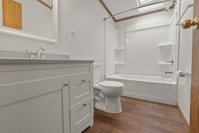 full bathroom with hardwood / wood-style floors, vanity, toilet, and shower / bath combination