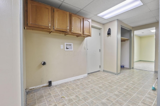 clothes washing area featuring hookup for a washing machine and cabinets