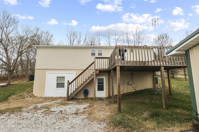 rear view of house featuring a wooden deck