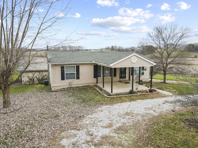 ranch-style home featuring cooling unit and a patio