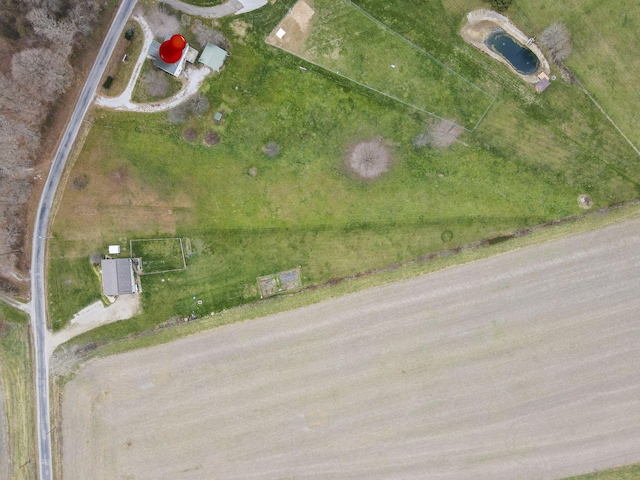 birds eye view of property with a rural view