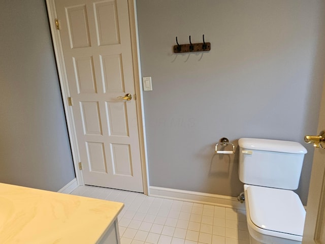 bathroom with tile patterned flooring, vanity, and toilet