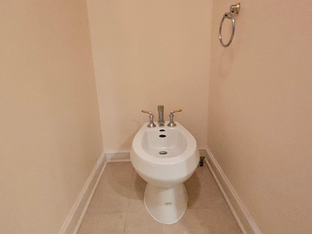 bathroom with tile patterned floors and a bidet