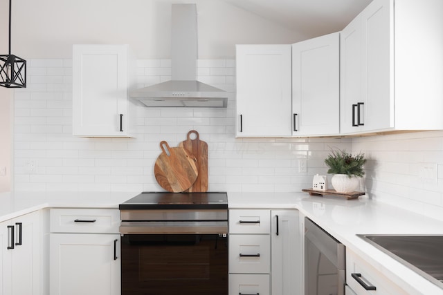 kitchen featuring wall chimney range hood, stainless steel dishwasher, backsplash, decorative light fixtures, and white cabinets