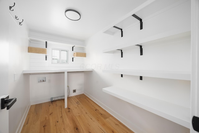 laundry room with washer hookup and light wood-type flooring