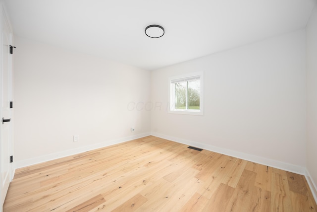 spare room featuring hardwood / wood-style flooring