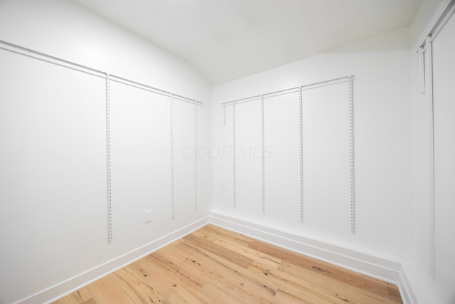 spacious closet with hardwood / wood-style floors and lofted ceiling