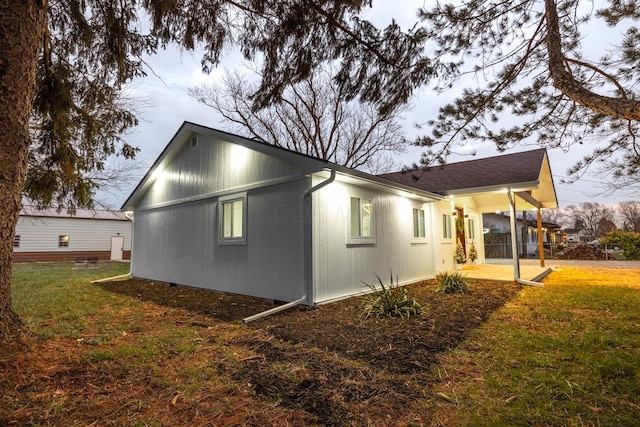 view of side of home featuring a yard